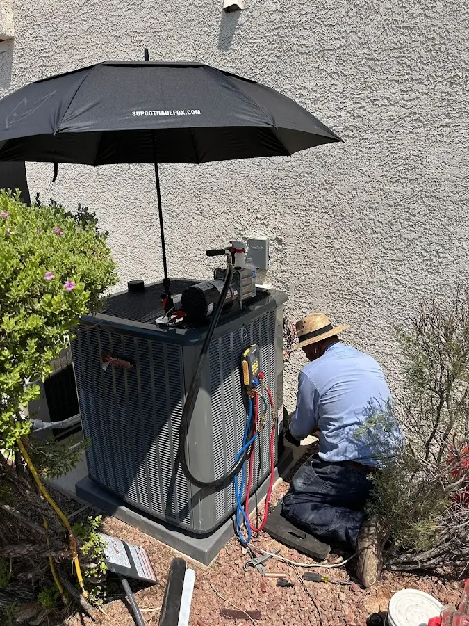 HVAC technician performing outdoor AC maintenance in Roanoke Rapids